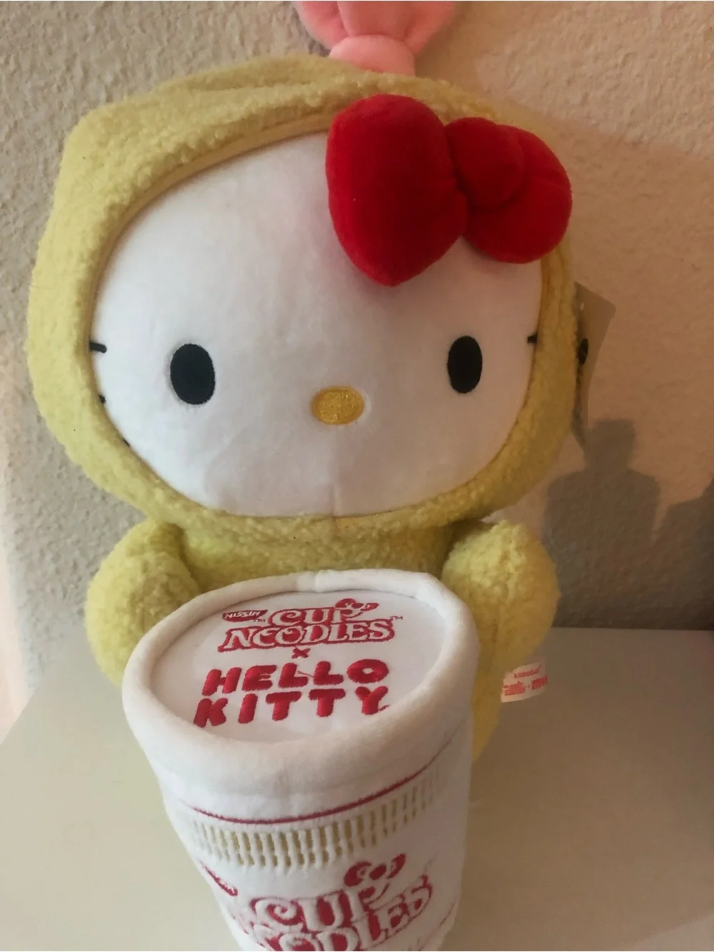 Hello Kitty Plush in Yellow Costume with Red Bow and White Cup Noodles Accessory